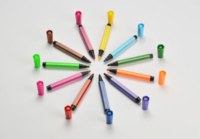 Close-up of multi colored felt tip pens over white background