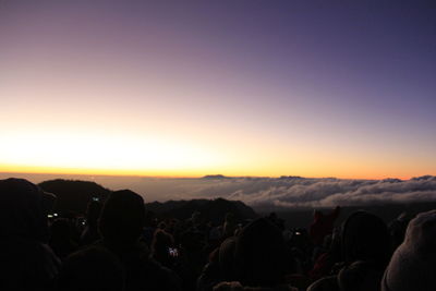 Crowd against sky during sunset