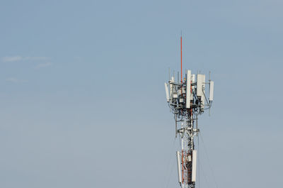 Low angle view of communications tower against sky