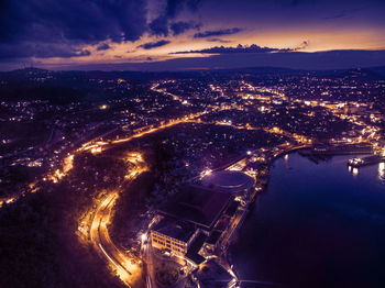 Aerial view of illuminated city against sky at night