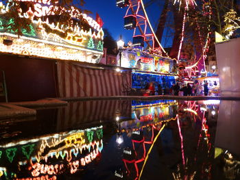 Illuminated ferris wheel at night