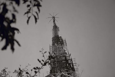 Low angle view of communications tower against sky