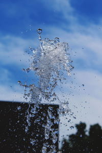 Close-up of water splashing against sky