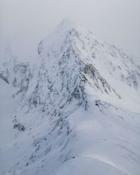 Scenic view of snow covered mountain against sky