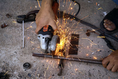 Low section of man working on barbecue grill