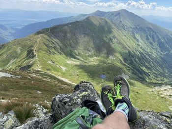 Low section of person against mountains