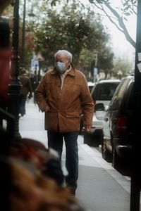 Man standing on street in city