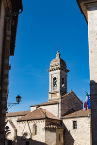 Low angle view of buildings against clear blue sky