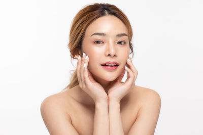 Portrait of a beautiful young woman over white background