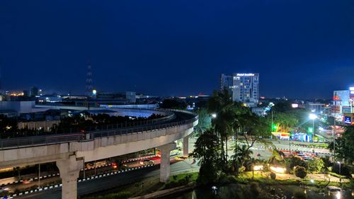 Illuminated city against sky at night