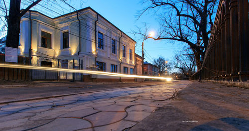 Surface level of road by buildings against sky