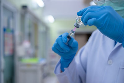 Midsection of person holding umbrella