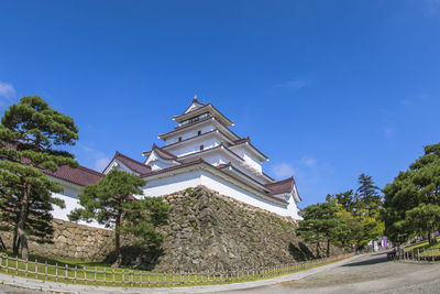 Low angle view of building against blue sky