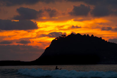 Scenic view of sea against orange sky