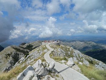 Scenic view of land and mountains against sky