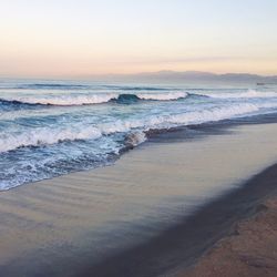 Scenic view of beach against sky during sunset