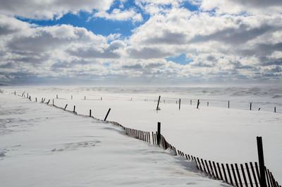 Scenic view of beach against sky during winter