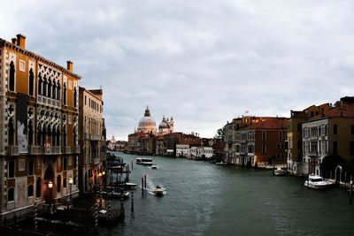Grand canal amidst buildings against cloudy sky