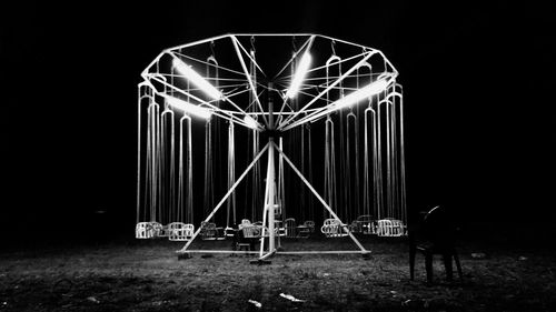 Illuminated ferris wheel at night