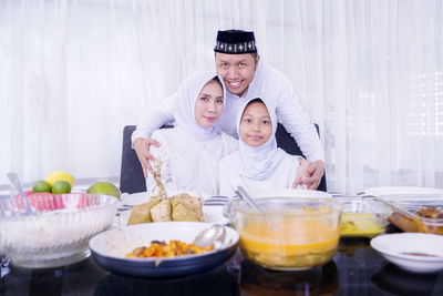 Portrait of father with daughter in bowl