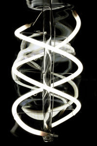 Close-up of illuminated lamp against black background