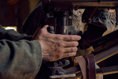 Close-up of man working in machine