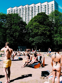 People at town square with city in background