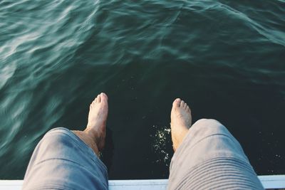 Low section of man relaxing over sea