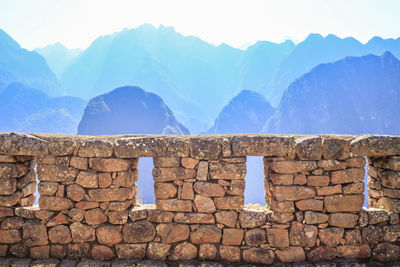 View of stone wall against mountain range