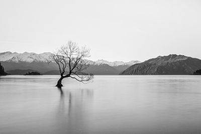 Scenic view of lake against sky during winter