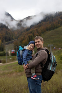 Portrait of young couple standing on field