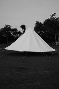 Tent on field against clear sky