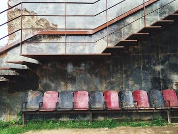 Old damaged empty chairs against steps