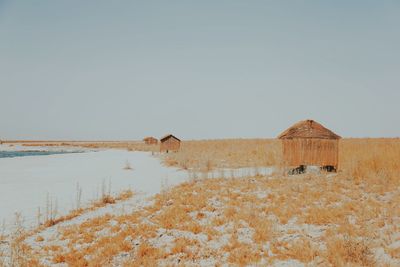 Huts on field against clear sky at atacama desert