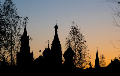 Silhouette of temple building against sky during sunset