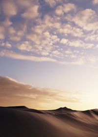 Scenic view of desert against sky during sunset