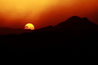 Silhouette of mountain range at sunset