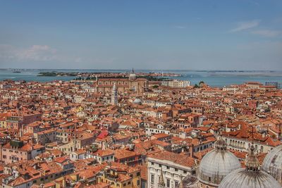 High angle view of townscape by sea against sky