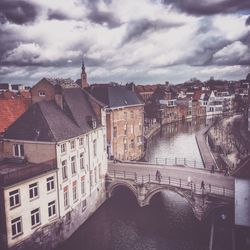 View of cityscape against cloudy sky