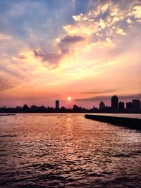 Scenic view of river at sunset