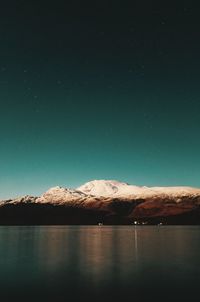 Scenic view of snowcapped mountains against sky at night