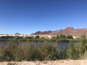 Scenic view of desert against clear blue sky