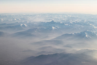 Aerial view of snowcapped mountains against sky