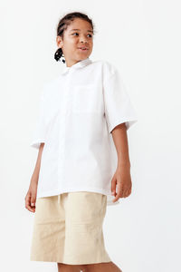 Portrait of man standing against white background