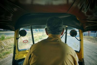 Rear view of man in car