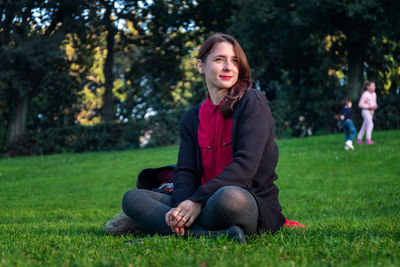 Portrait of woman sitting in park