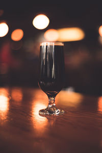 Close-up of illuminated lamp on table