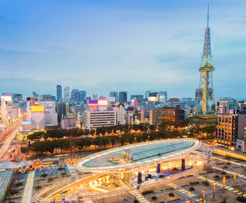 High angle view of city buildings against cloudy sky