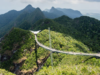 Scenic view of langkawi sky bridge between mountains against sky
