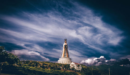 Low angle view of monument and building against sky